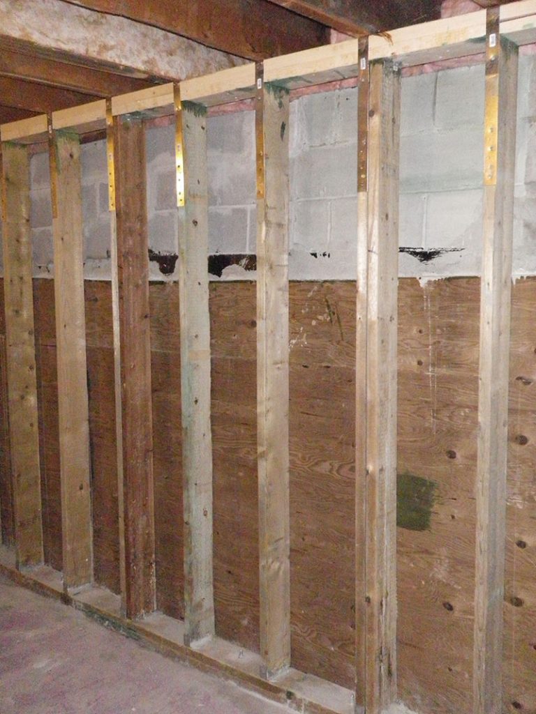 9 Wall plywood shim is installed up to grade level and top of wall is